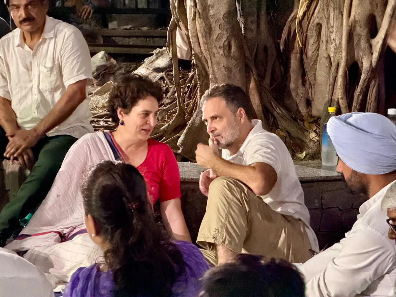Rahul Gandhi and Priyanka Gandhi Vadra seated under a tree inside Akashvani Bhawan during the 6 October 2026 protest over the SIR voter-roll controversy