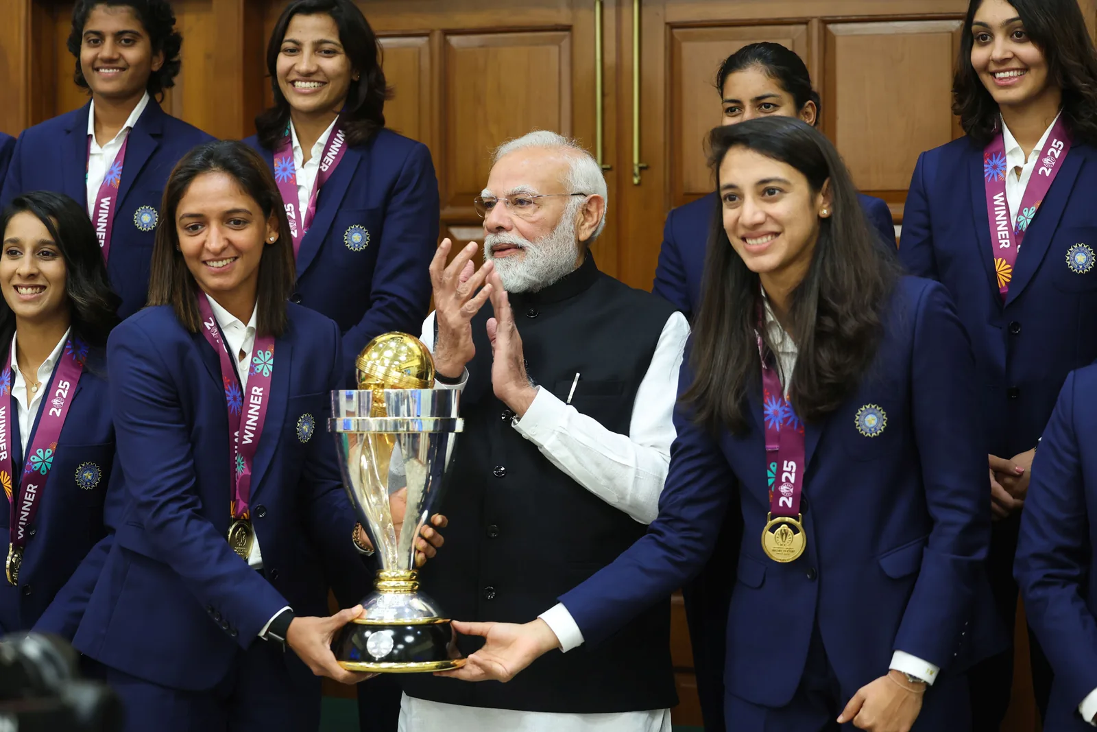 India's 2025 Women's Cricket World Cup-winning team poses with its trophy at 7 Lok Kalyan Marg in New Delhi on 5 November 2025