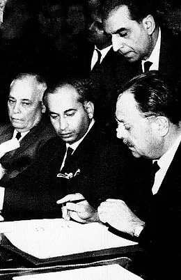 Pakistani-Indian peace negotiations end successfully in Tashkent: Photograph shows Pakistani President Ayub Khan signing the Tashkent Agreement on 10 January 1966, with Aziz Ahmed looking on; not a photograph of the entire negotiating process.