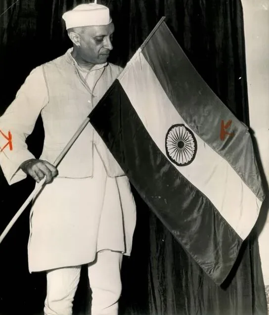 National Flag adopted: Nehru photographed with the newly adopted Indian national flag in July 1947, the same month it was adopted by the Constituent Assembly. Not a photograph of the actual adoption vote.