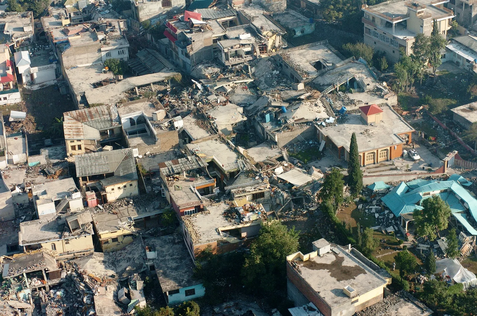The 2005 Kashmir earthquake kills about 80,000 people: United States Navy photograph of earthquake destruction in Muzaffarabad, Pakistan-administered Kashmir on 13 October 2005, five days after the 8 October disaster; not an image taken at the moment of the quake.