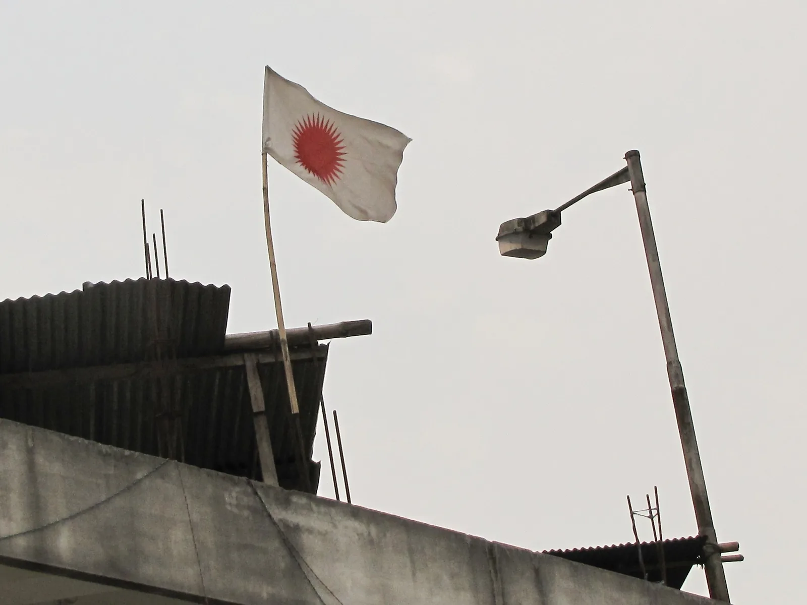 Talom Rukbo and his companions founded the Donyi-Polo Yelam Kebang: 2012 photograph of a Donyi-Polo religious flag outside a house in Itanagar; a symbol associated with a tradition organized by Talom Rukbo, not a photograph of the founding of the Donyi-Polo Yelam Kebang in 1986.
