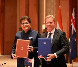 Official photograph of Piyush Goyal and Todd McClay displaying the signed India–New Zealand Free Trade Agreement, 27 April 2026. The agreement entered into force on 20 October 2026.
